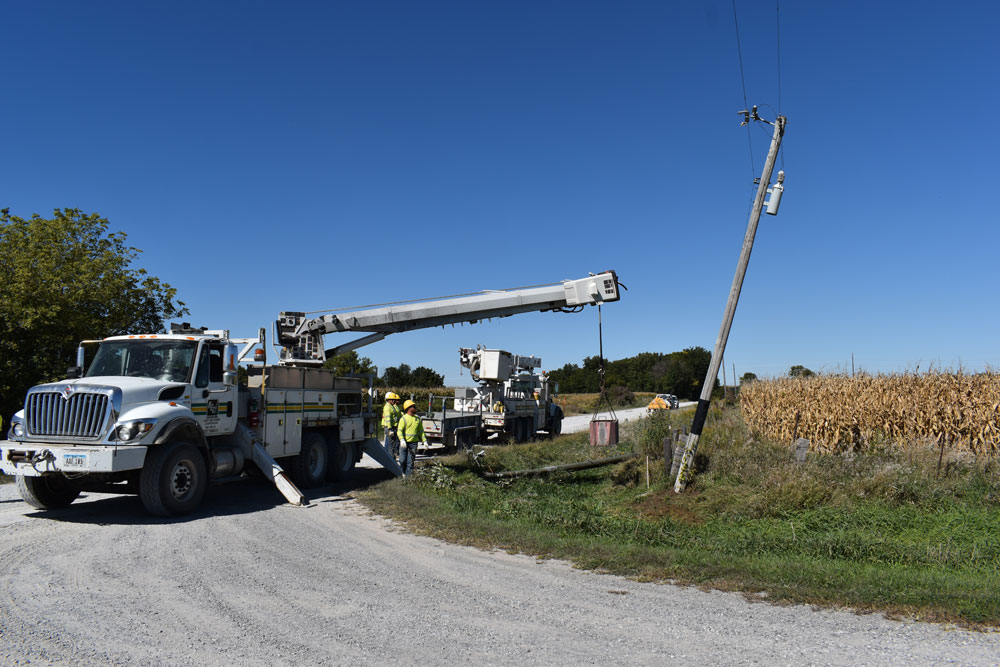 truck and linemen fixing pole